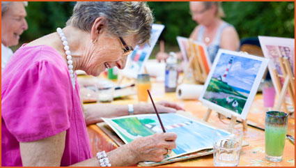 Senior doing painting during the activities and events at Carolina Highlands